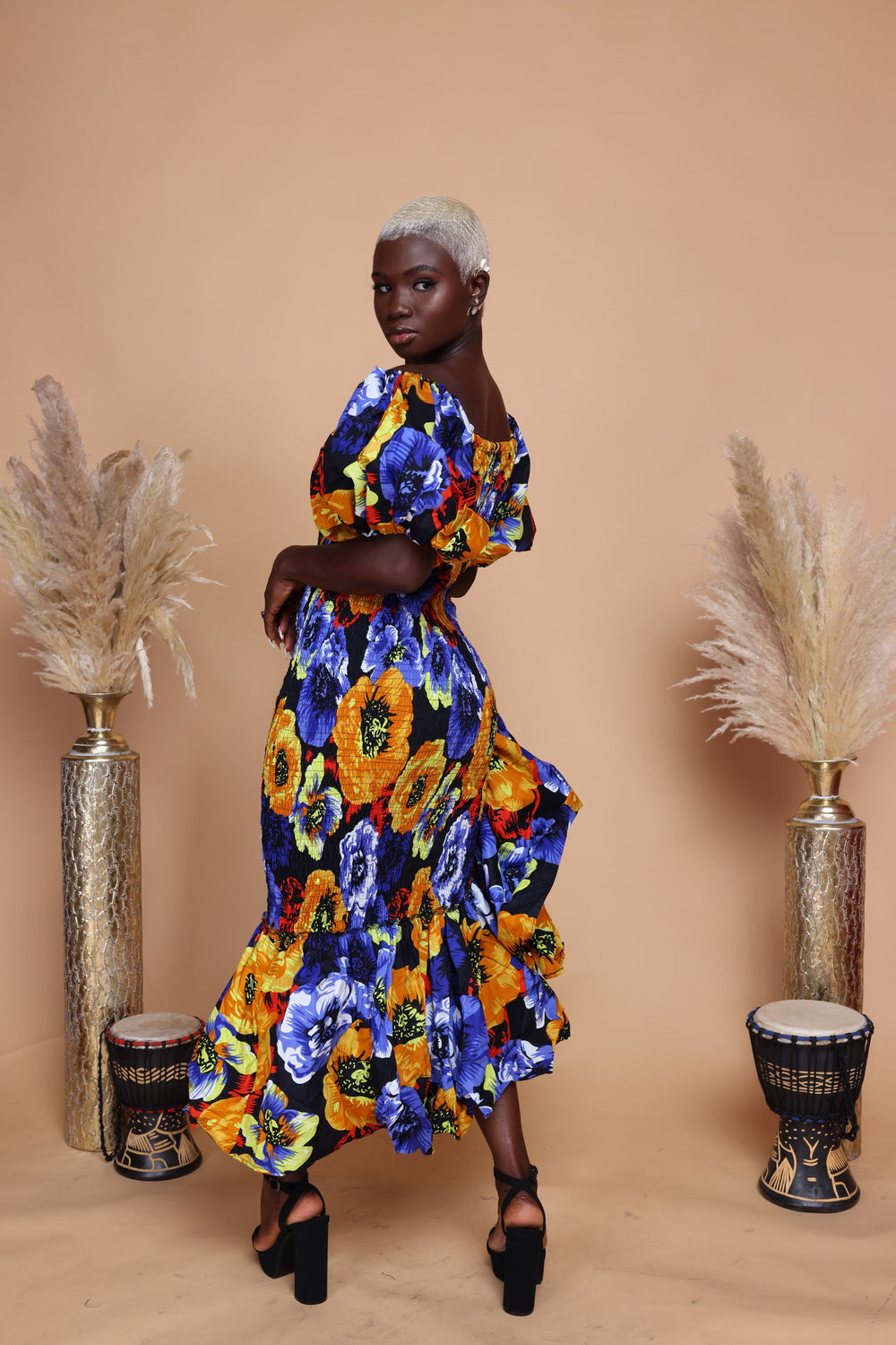 African print smoke body-con dress with puffy sleeves and ruffles on the side.
